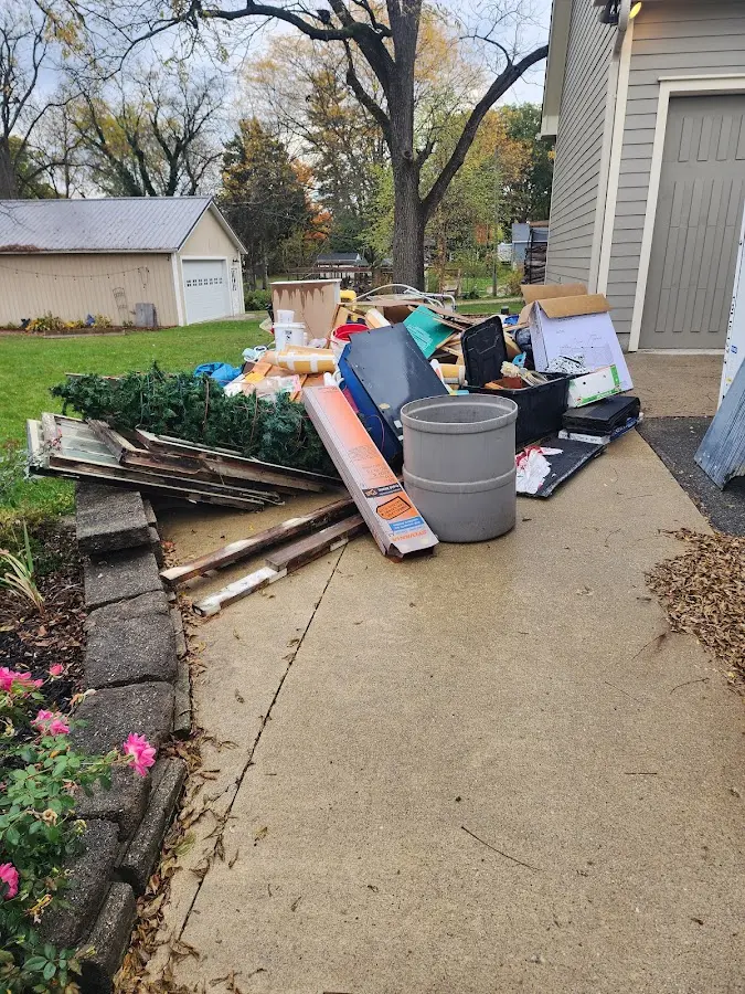 Dumpster being loaded with debris for Estate Cleanout Dumpster Rental in East Fallowfield